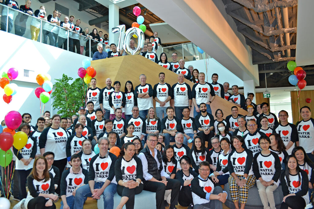 A big group of people posing for company photo